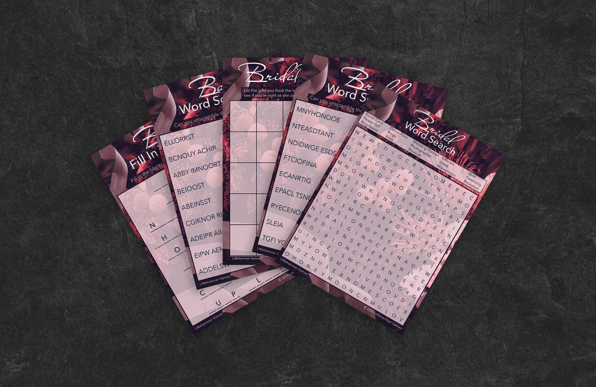 Dark floral game cards fanned out on a slate background