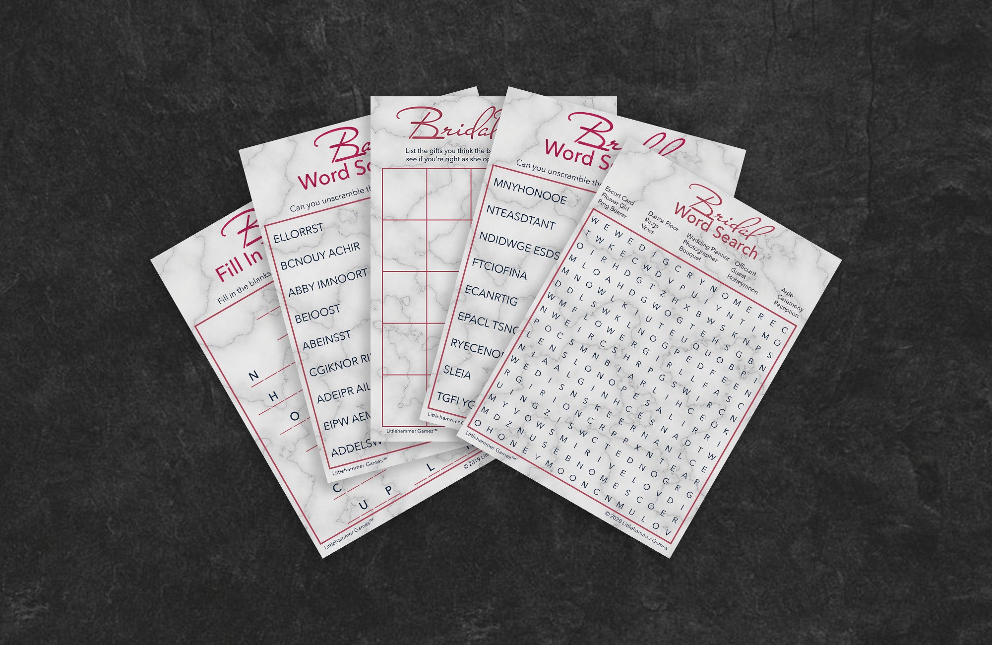 Rose gold and marble game cards fanned out on a slate background