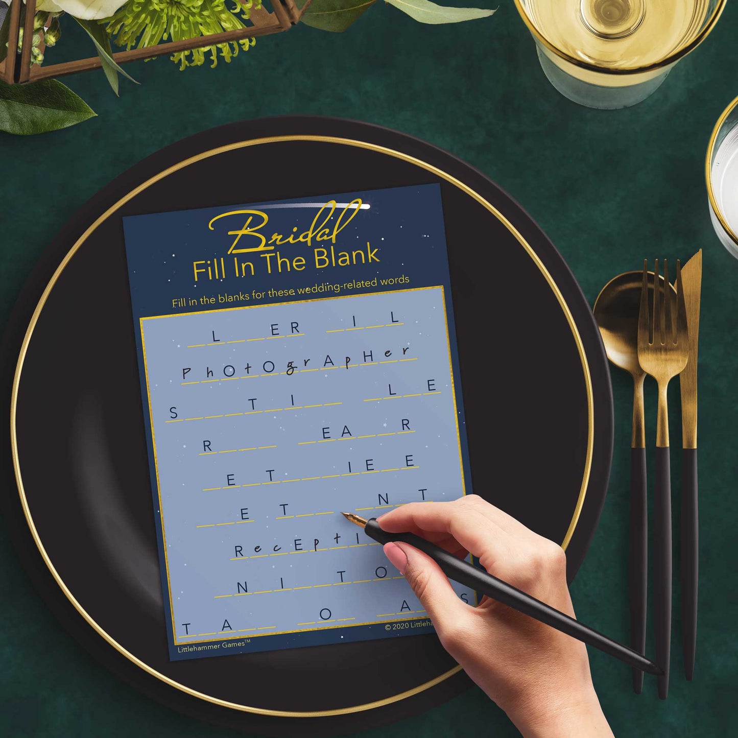 Woman with a pen playing a celestial-themed Bridal Fill in the Blank game card at a dark place setting