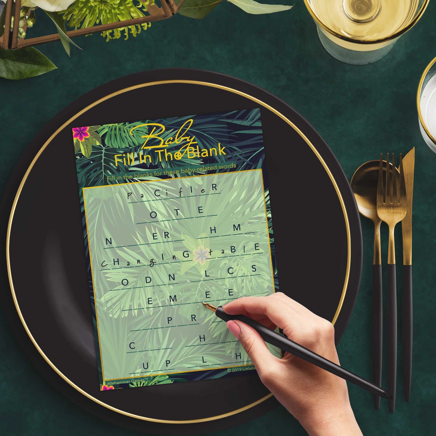 Woman with a pen playing a tropical Baby Fill in the Blank game card at a dark place setting