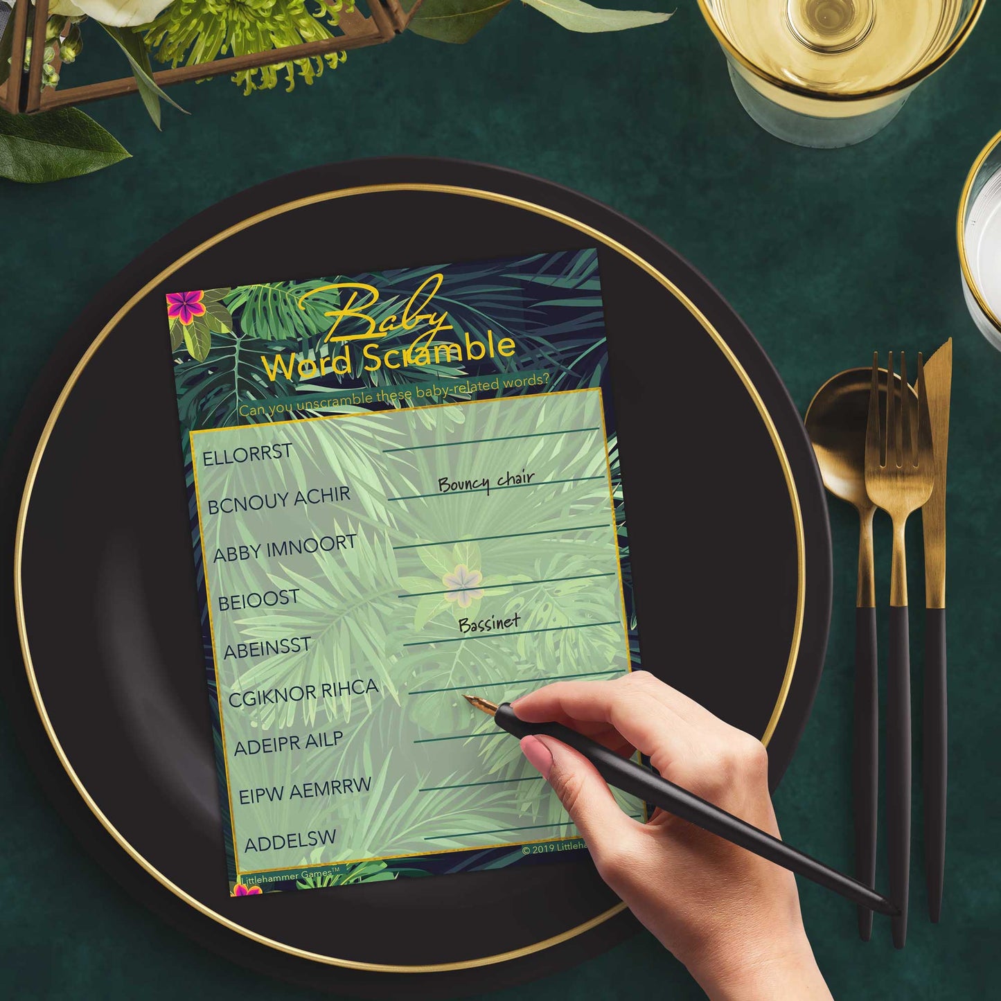 Woman playing a tropical Baby Word Scramble game card at a green and black place setting