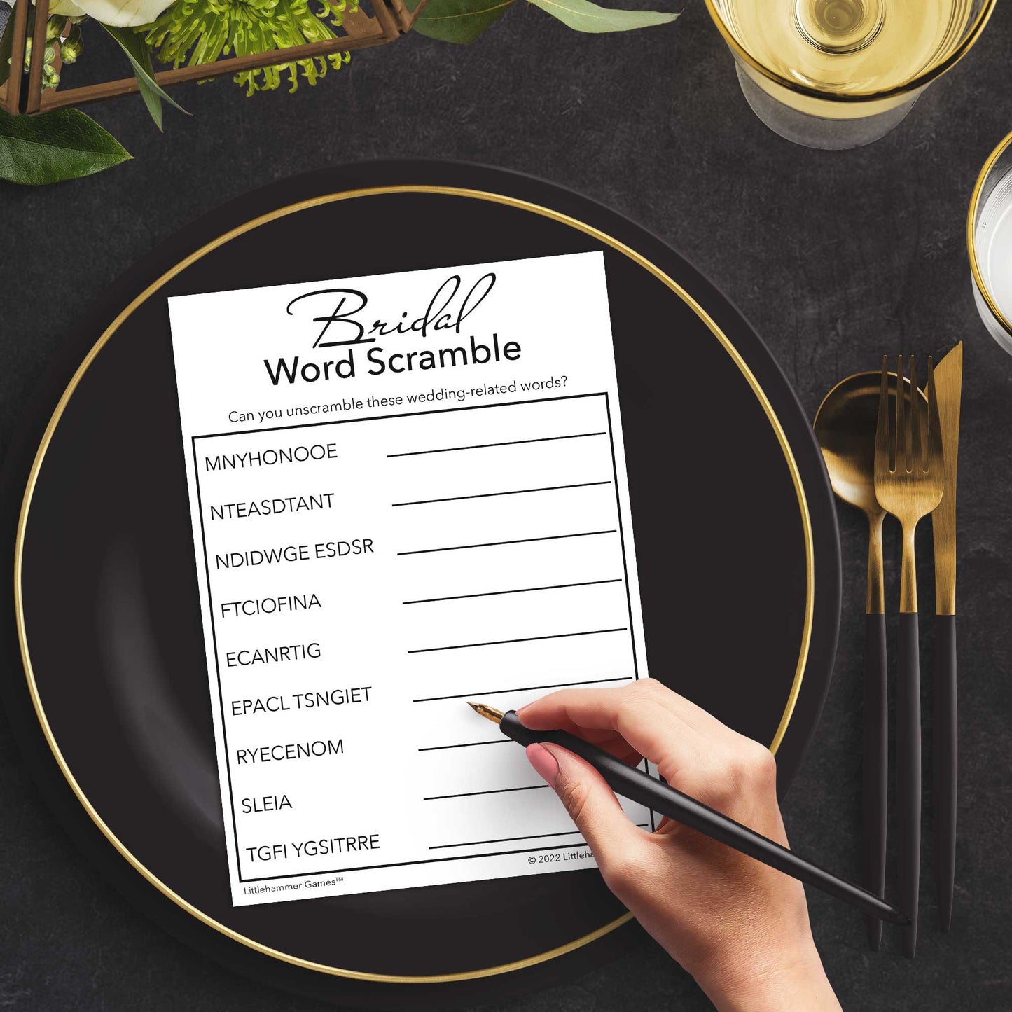 Woman with a pen playing a black and white Bridal Word Scramble game card at a dark place setting