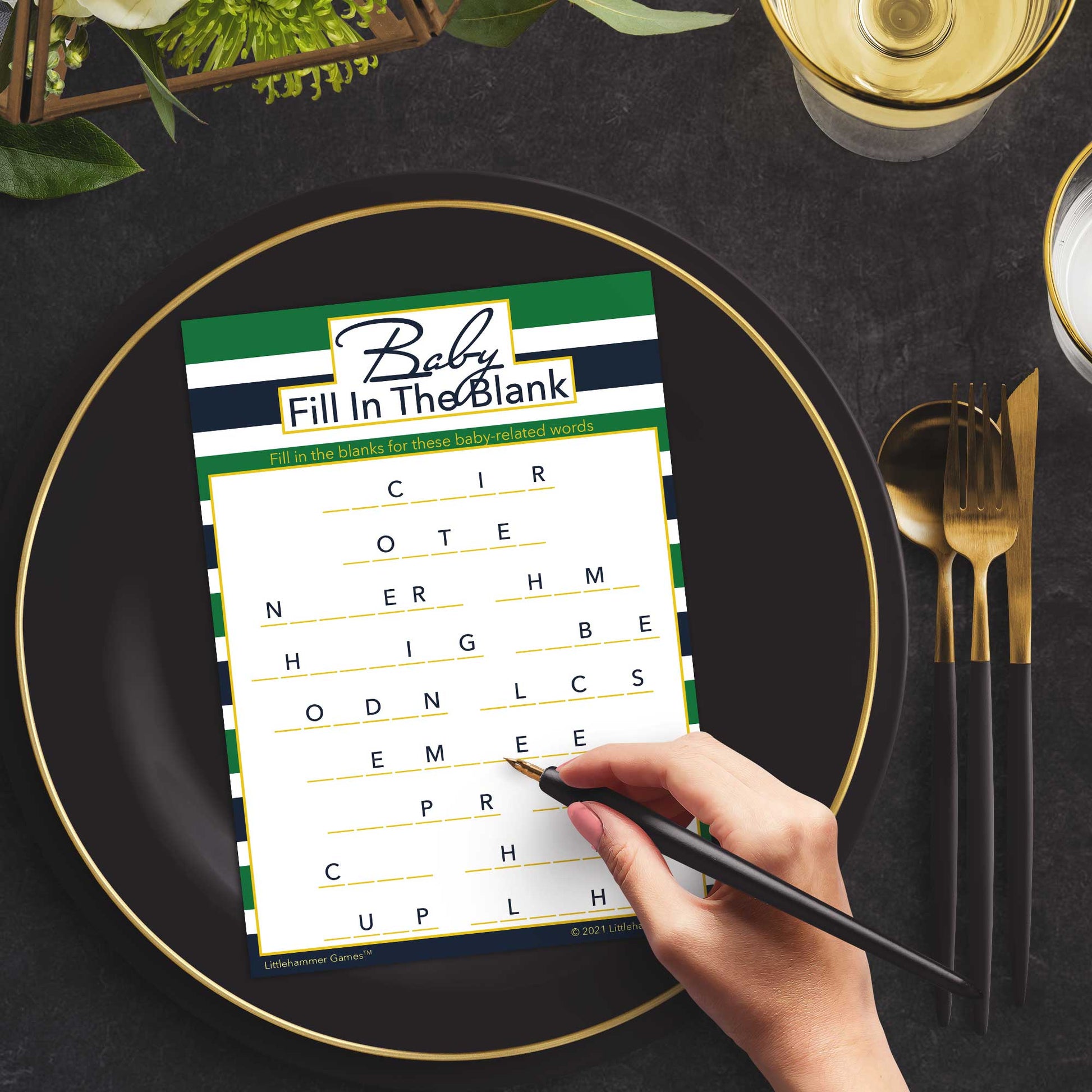 Woman with a pen playing a green and navy-striped Baby Fill in the Blank game card at a dark place setting