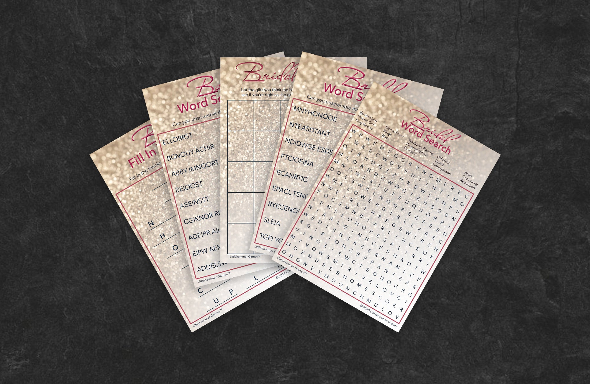 Glittery rose gold game cards fanned out on a slate background