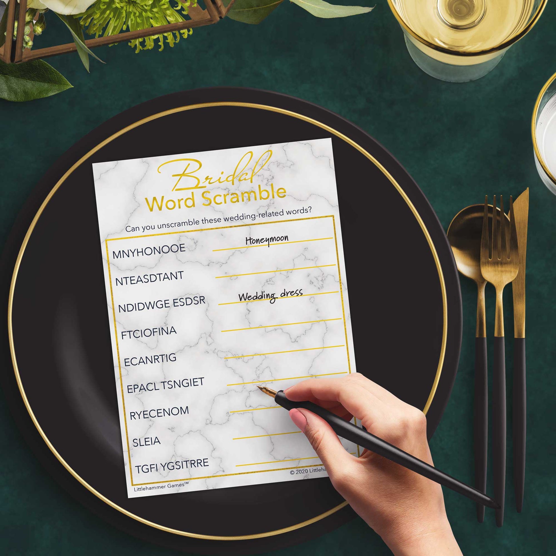 Woman with a pen playing a gold and marble Bridal Word Scramble game card at a dark place setting