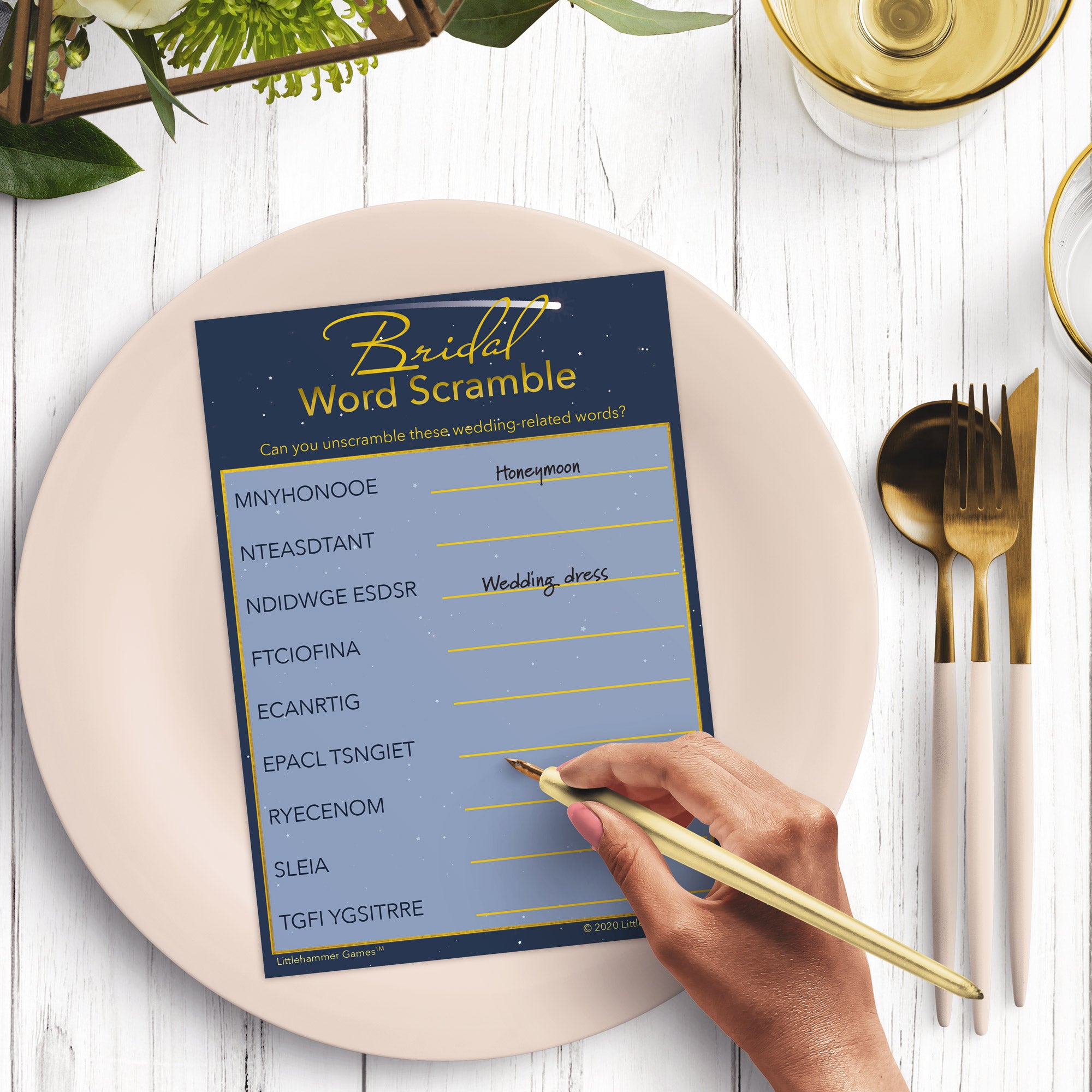 Woman with a pen playing a celestial-themed Bridal Word Scramble game card at a dark place setting