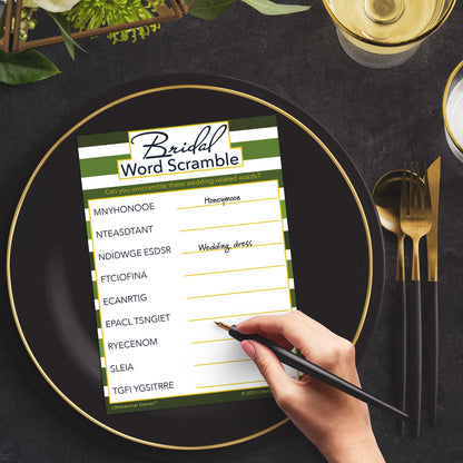 Woman with a pen playing a green-striped Bridal Word Scramble game card at a dark place setting