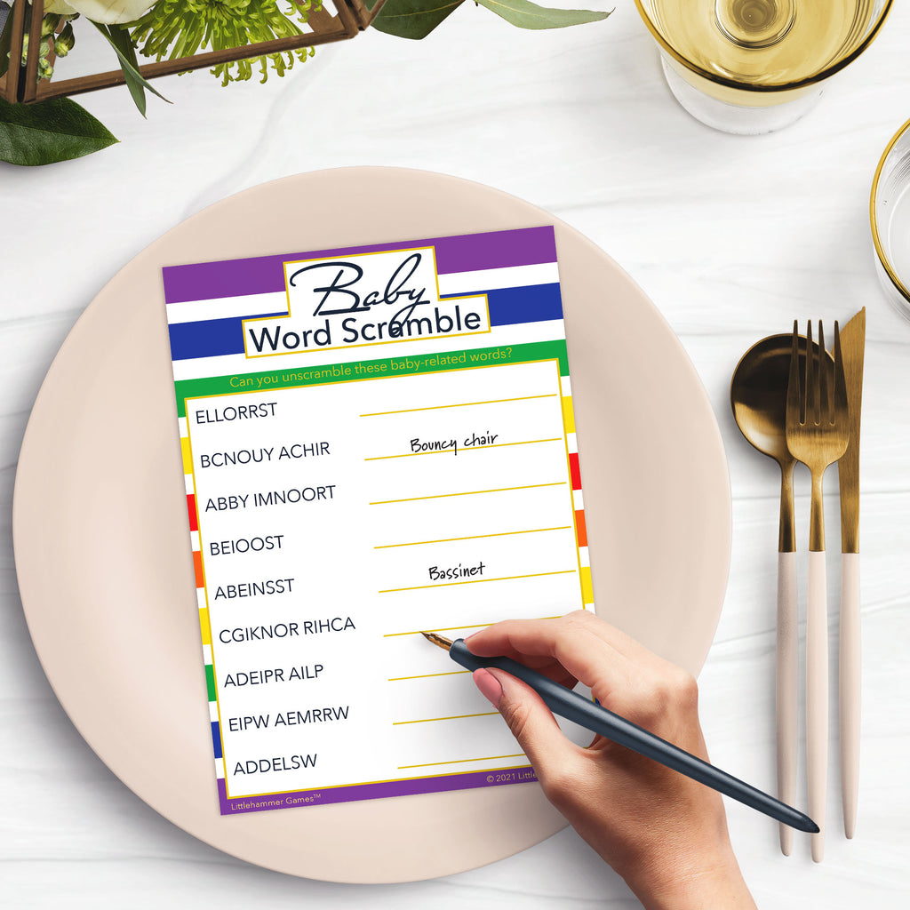 Woman playing a rainbow-striped Baby Word Scramble game card at a green and black place setting
