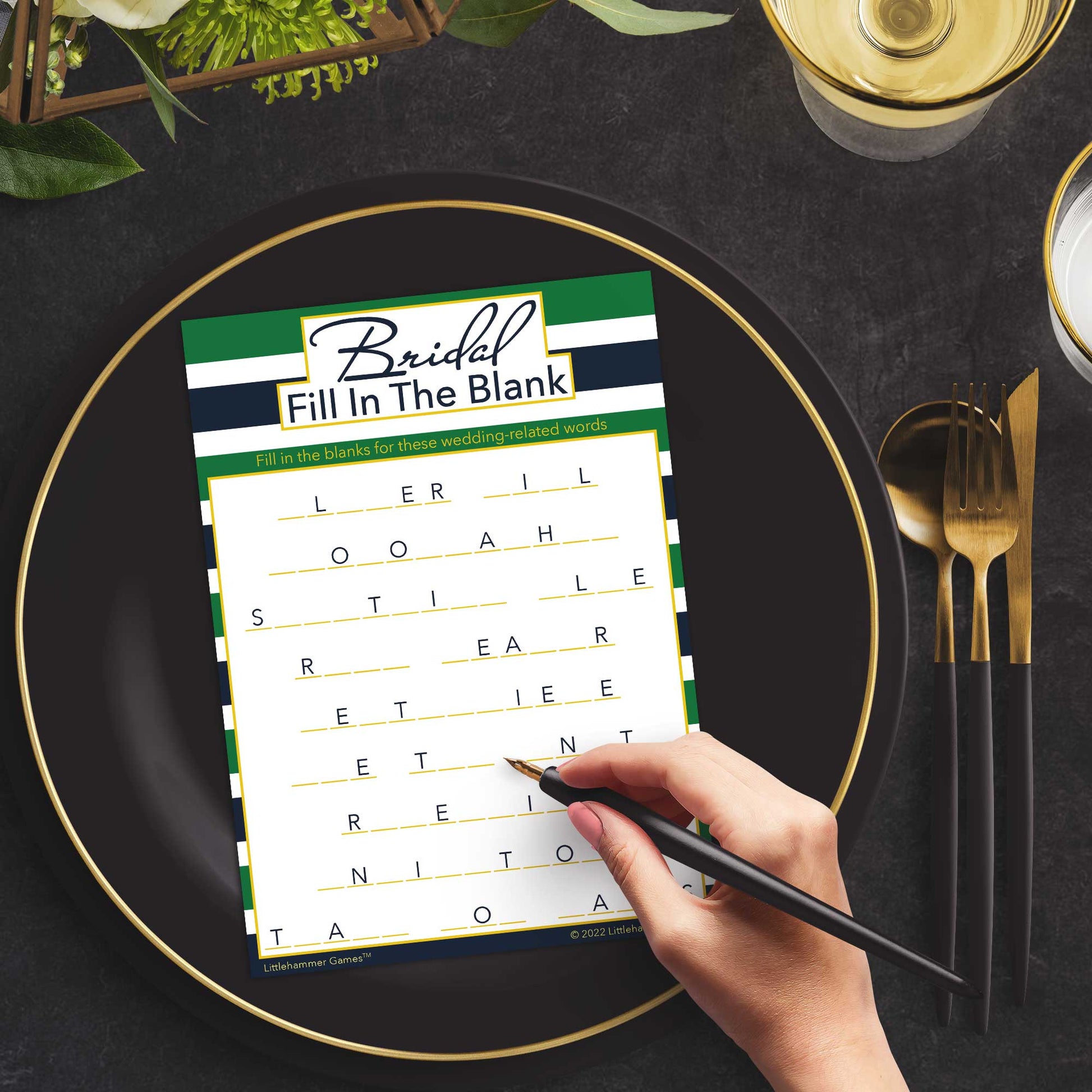 Woman with a pen playing a green and navy-striped Bridal Fill in the Blank game card at a dark place setting