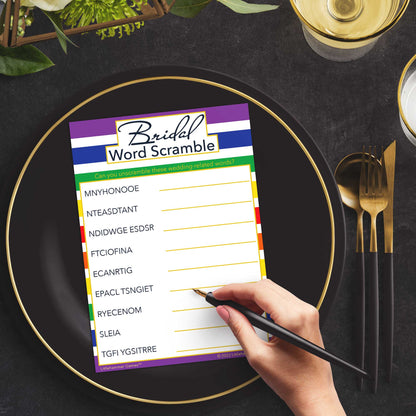 Woman with a pen playing a rainbow-striped Bridal Word Scramble game card at a dark place setting