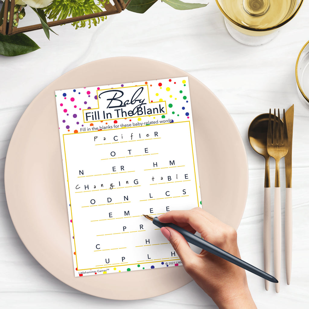 Woman with a pen playing a rainbow polka dot Baby Fill in the Blank game card at a dark place setting