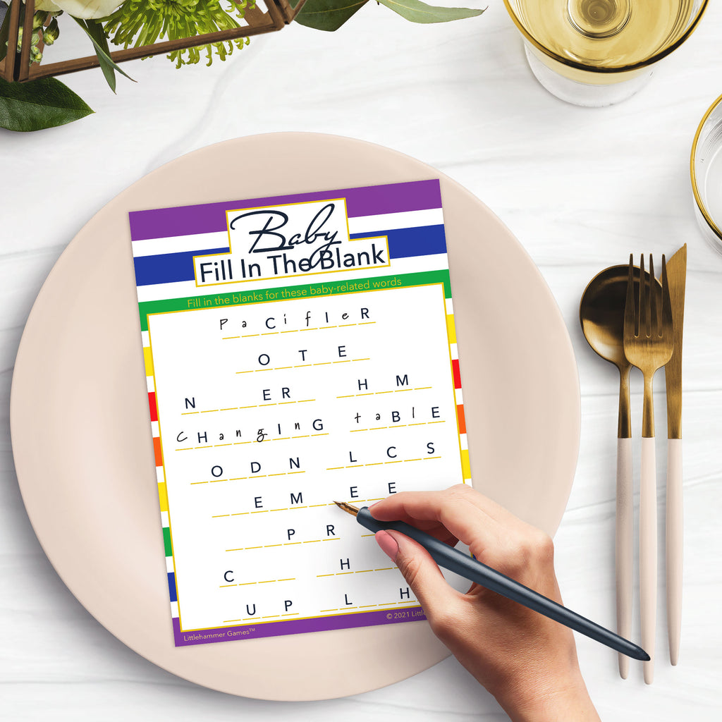 Woman with a pen playing a rainbow-striped Baby Fill in the Blank game card at a dark place setting