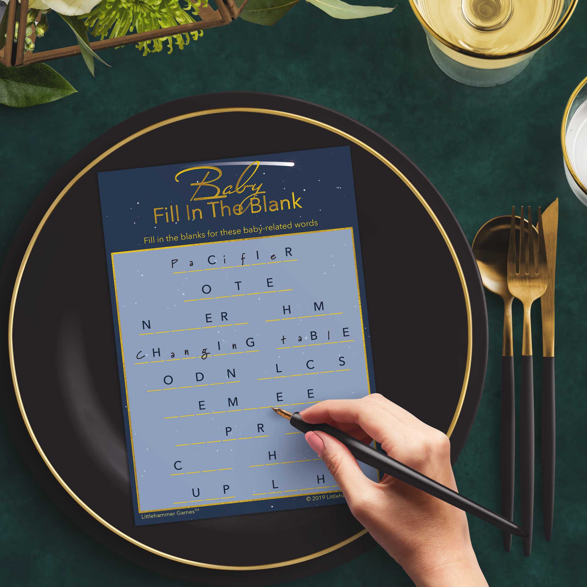 Woman with a pen playing a shooting star Baby Fill in the Blank game card at a dark place setting
