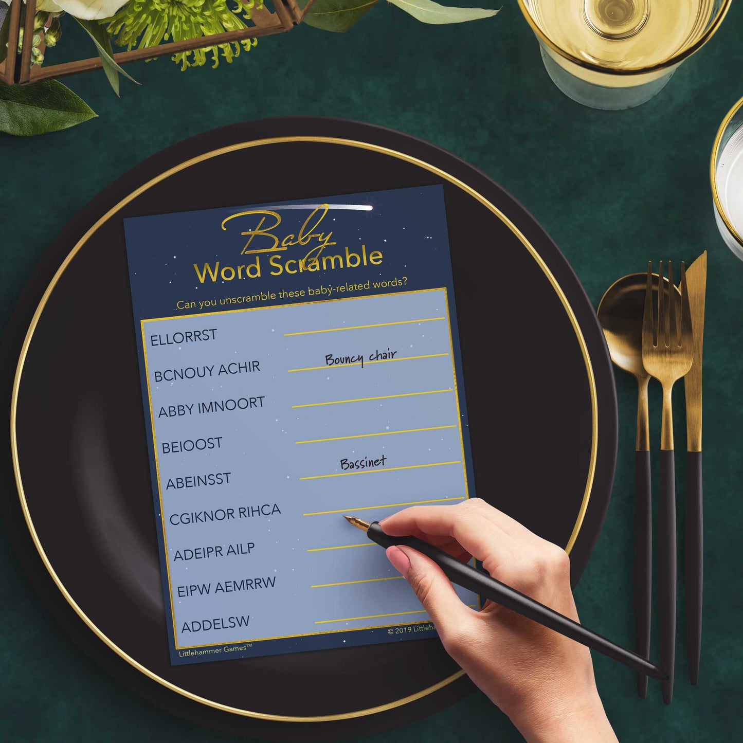 Woman playing a celestial Baby Word Scramble game card at a green and black place setting